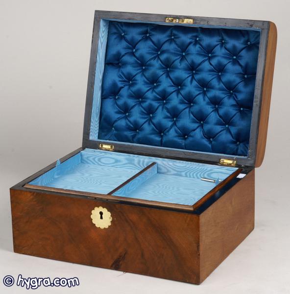 JB230: A curved top figured walnut box with brass escutcheon working lock and key, replacement tray. circa1890. Enlarge Picture